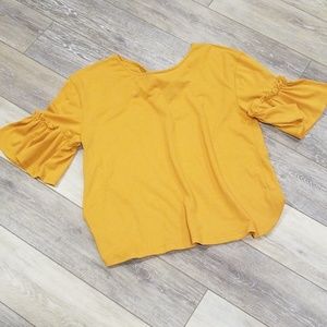Bell sleeve mustard top with knot detail in back